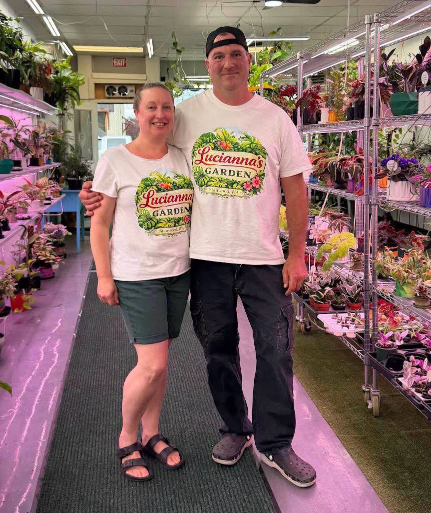 Darren and Janelle Lucianna standing in their plant-filled shop